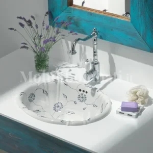 lavabo con motivi floreali blu su ceramica bianca.